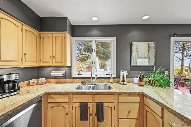 a large kitchen with a lot of counter space and a wooden floor