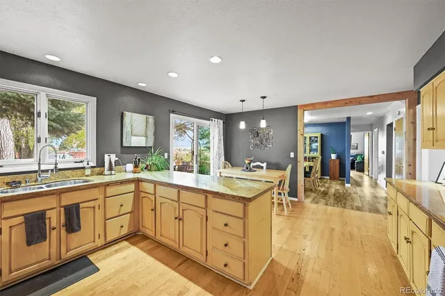 a kitchen with granite countertop a sink stainless steel appliances and cabinets
