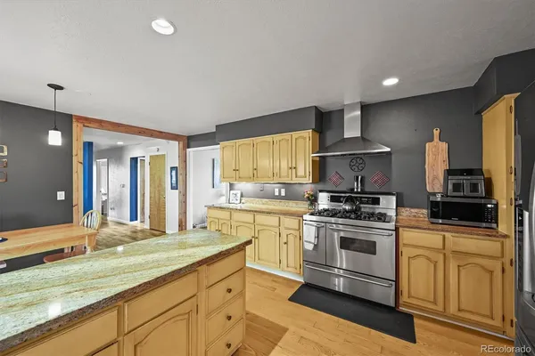 a kitchen with a refrigerator sink and cabinets