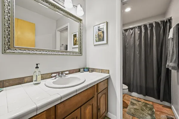 a white toilet sitting next to a shower curtain