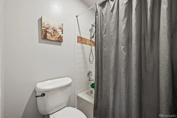 a bedroom with a bed chair and window