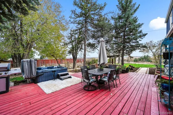 a view of a roof deck with table and chairs couches and a fire pit