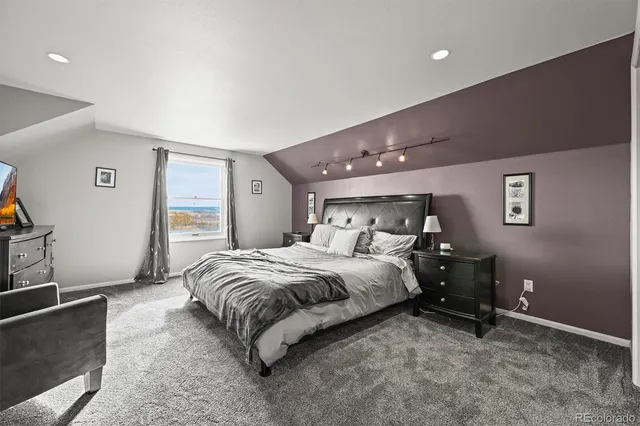 a spacious bedroom with a bed and a couch