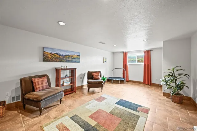 a living room with furniture and a potted plant