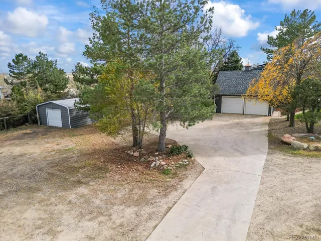 a view of a yard with a house in the background
