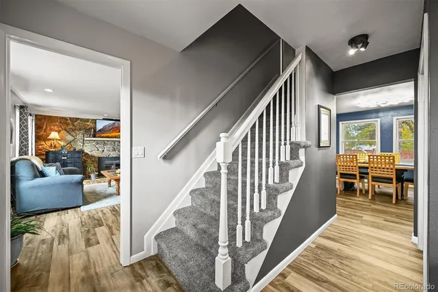 a view of staircase with wooden floor and furniture