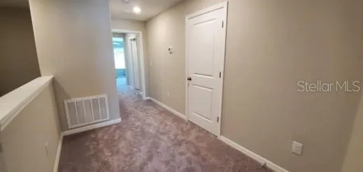 a view of hallway with bathroom