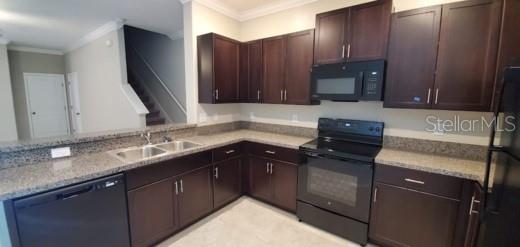 11859 Dumaine Valley Road Riverview, FL 33579 - Photo 3 of 19 a kitchen with a sink stove and cabinets