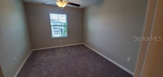 11859 Dumaine Valley Road Riverview, FL 33579 - Photo 10 of 19 an empty room with windows and chandelier fan