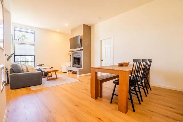 a dining room with furniture and wooden floor