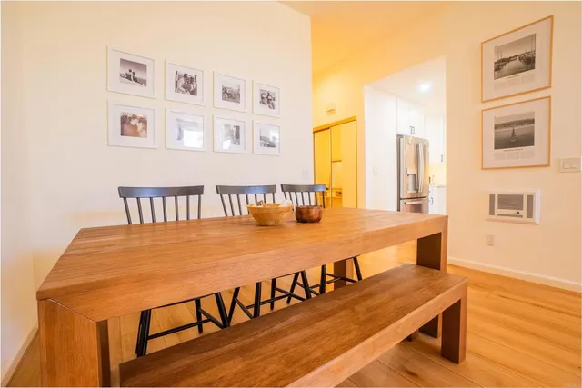 a dining room with furniture and wooden floor