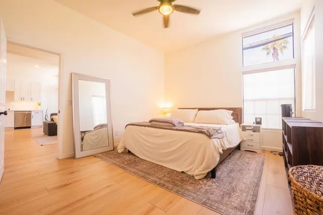 a spacious bedroom with a bed and a chandelier