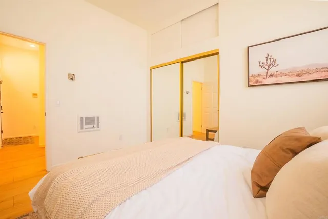 a bedroom with a bed and a painting on the wall