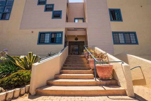 a view of a patio with couches and potted plants