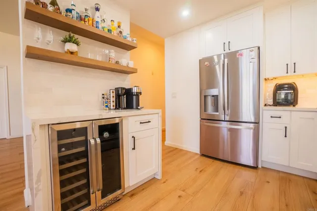 a kitchen with stainless steel appliances a refrigerator and a stove top oven