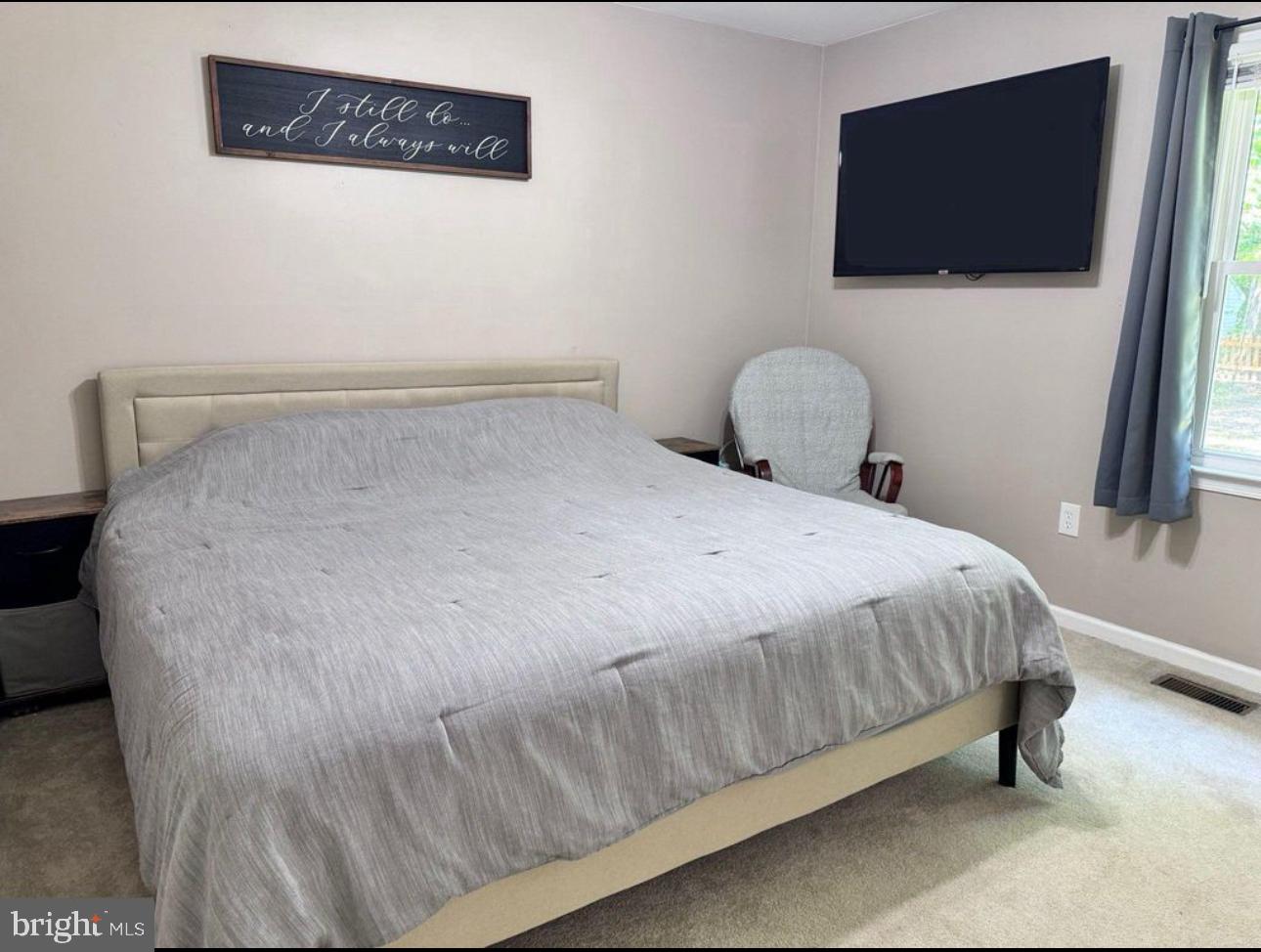 608 Tacketts Mill Road Stafford, VA 22556 - Photo 15 of 20 a large bed sitting in a bedroom next to a window
