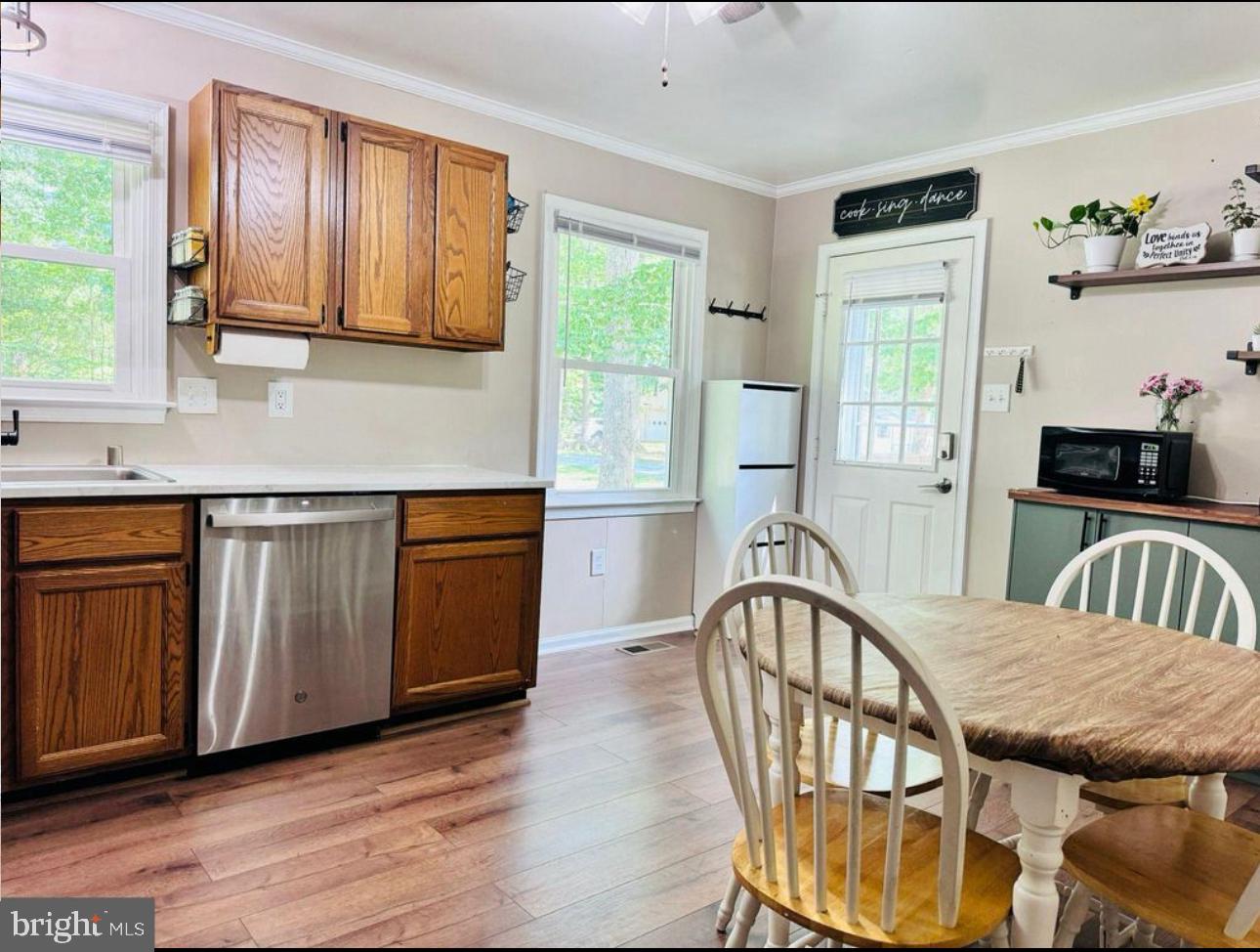 608 Tacketts Mill Road Stafford, VA 22556 - Photo 3 of 20 a view of a kitchen filled with furniture hardwood floor and a window