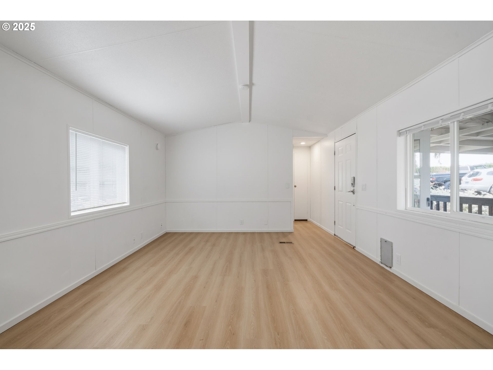 35440 Highway 211, Unit 12 Boring, OR 97009 - Photo 12 of 27 a view of an empty room with wooden floor and a window