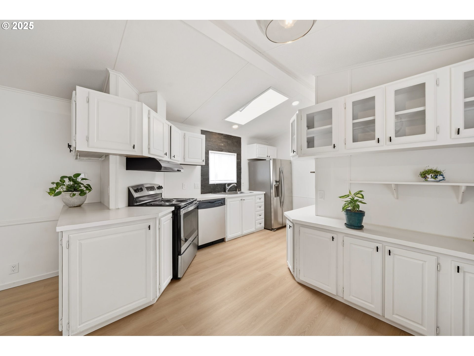 35440 Highway 211, Unit 12 Boring, OR 97009 - Photo 4 of 27 a kitchen with cabinets and white appliances