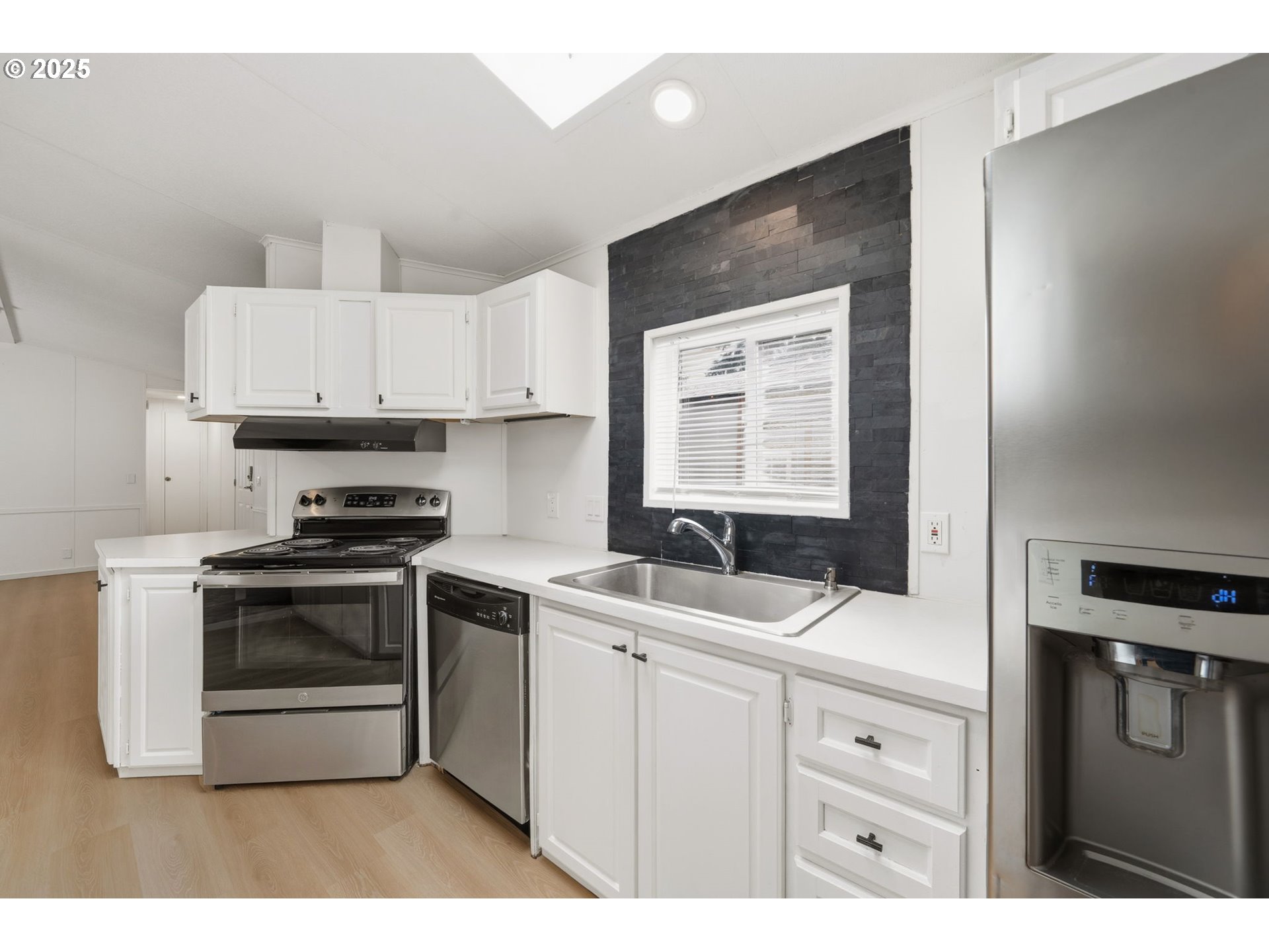 35440 Highway 211, Unit 12 Boring, OR 97009 - Photo 8 of 27 a kitchen with stainless steel appliances white cabinets and a stove top oven