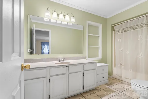 a bathroom with a double vanity sink mirror and