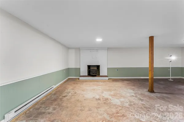a view of an empty room with a fireplace