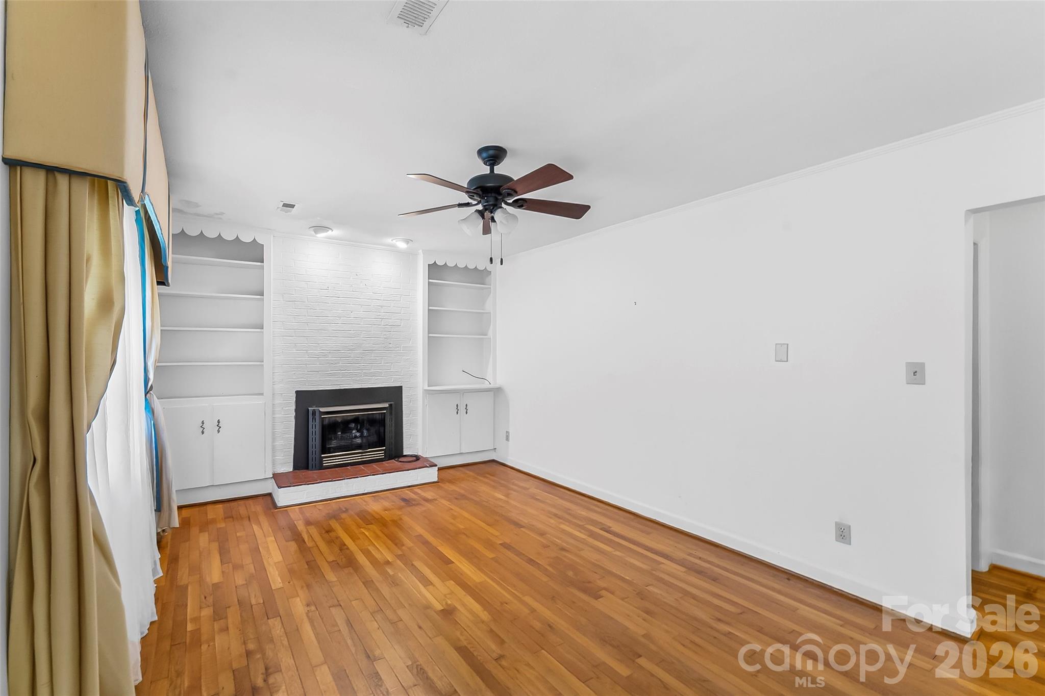 512 Paxton Creek Road Marion, NC 28752 - Photo 5 of 34 a view of empty room with a fireplace and wooden floor