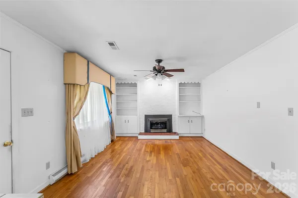 wooden floor in an empty room with a fireplace