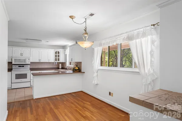 a kitchen with stainless steel appliances granite countertop a stove and a sink