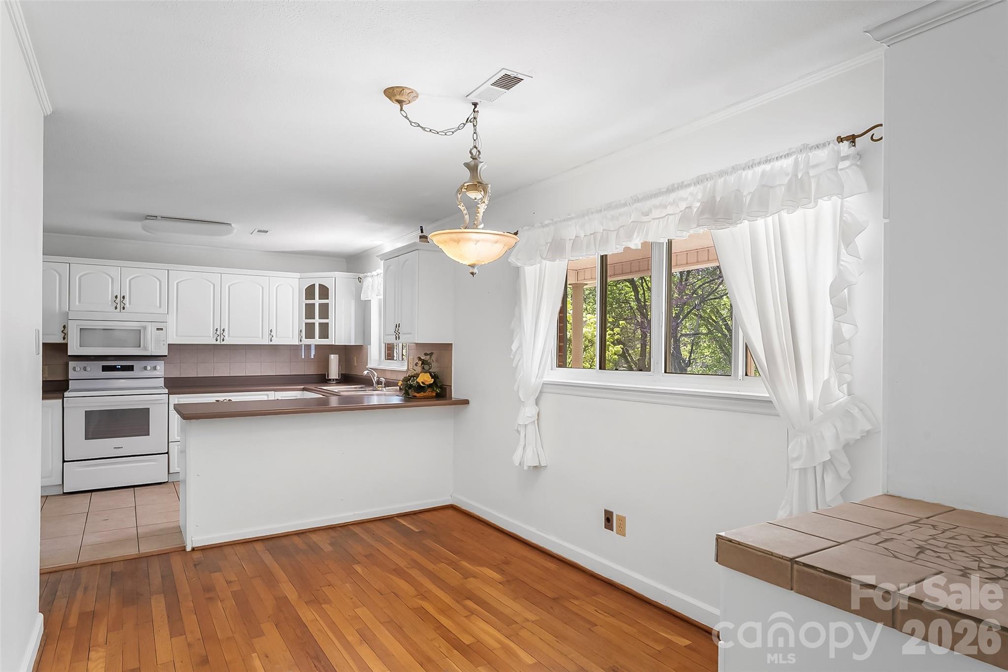 512 Paxton Creek Road Marion, NC 28752 - Photo 9 of 34 a kitchen with stainless steel appliances granite countertop a stove and a sink