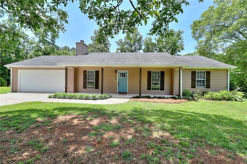 129 Barrett Woods Road Covington, GA 30014 - Photo 1 of 1 front view of a house with a yard