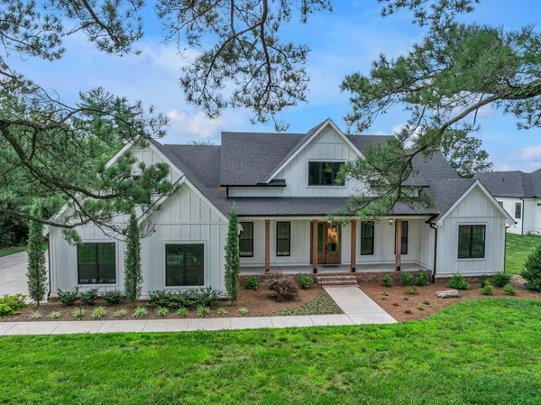 a front view of a house with a big yard