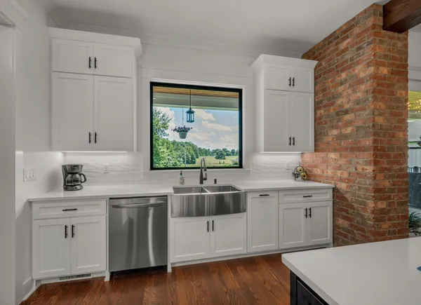 a view of a patio with table and chairs and potted plants with wooden floor