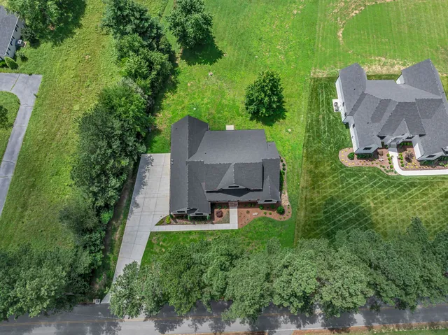 a front view of a house with swimming pool and porch with outdoor seating