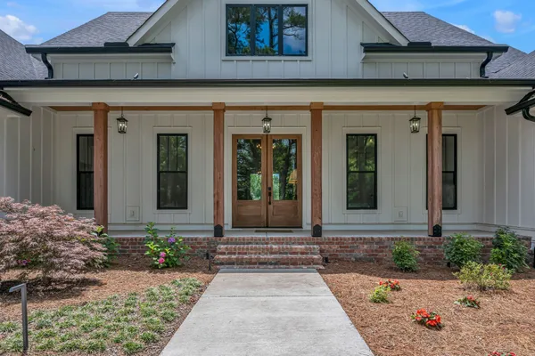 a kitchen with stainless steel appliances granite countertop a sink a stove and a wooden floors