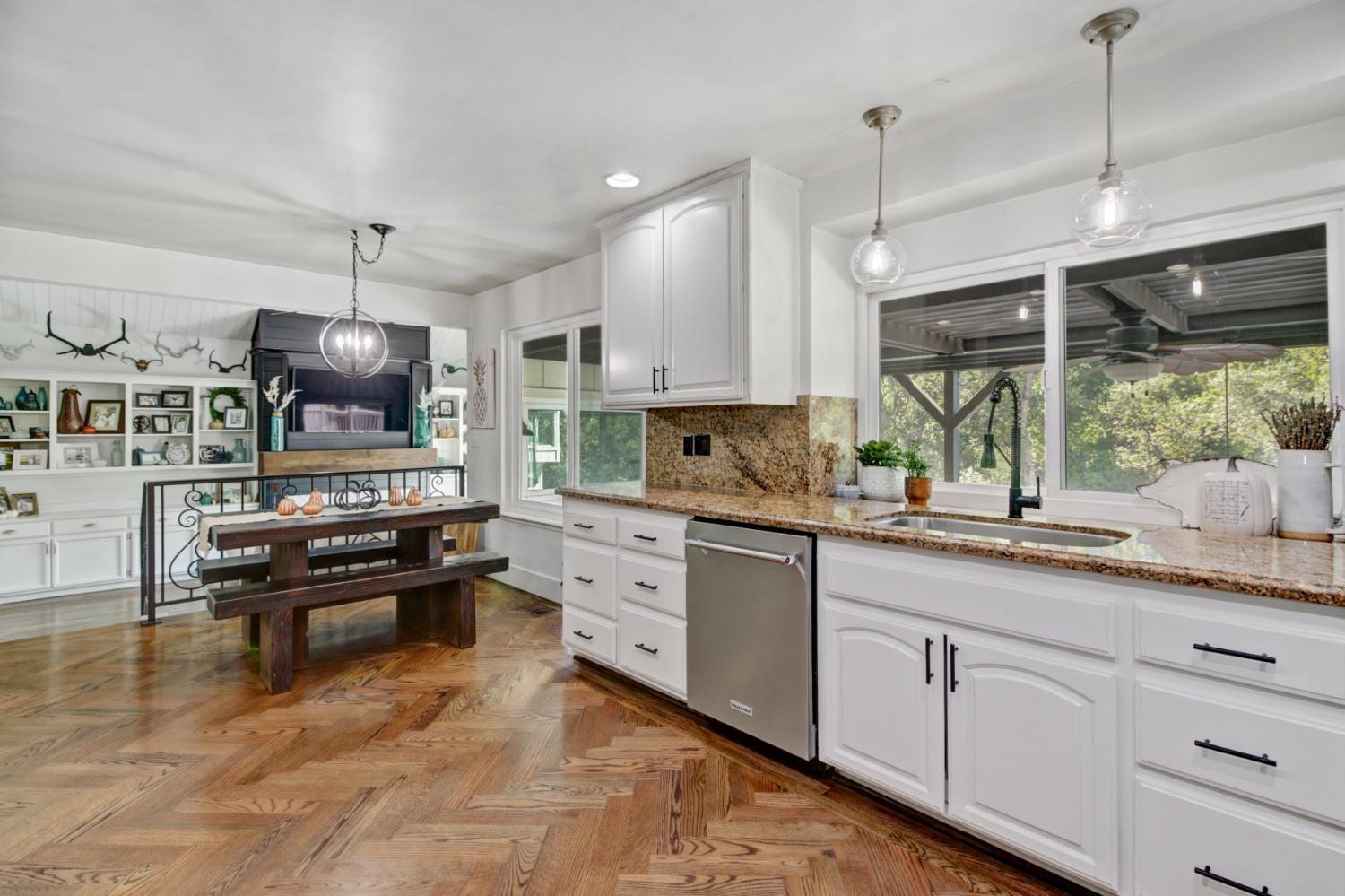 2239 Seabler Place Carmichael, CA 95608 - Photo 21 of 68 a kitchen with kitchen island granite countertop a stove a sink a center island and living room view