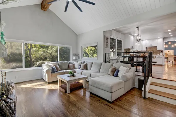 a bedroom with a bed window and couch
