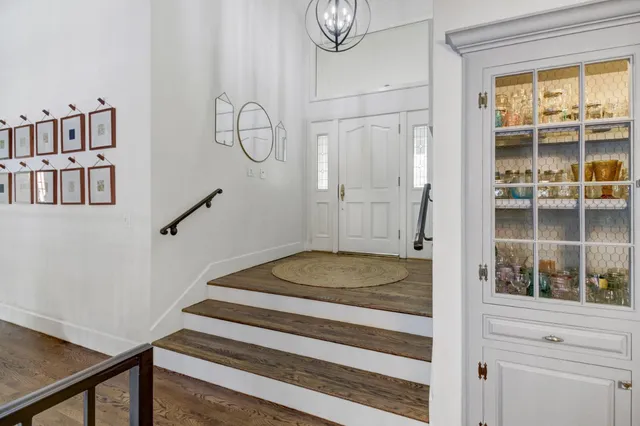 a living room with furniture and a table with wooden floor