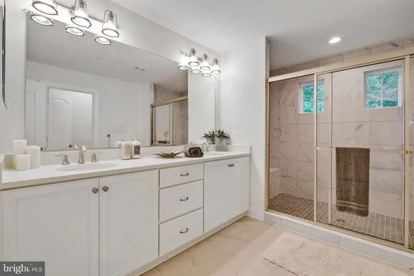 a bathroom with double sink and a mirror