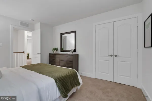 a bedroom with a bed and a lamp