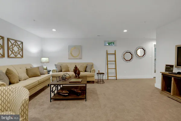 a living room with furniture a rug and a fireplace