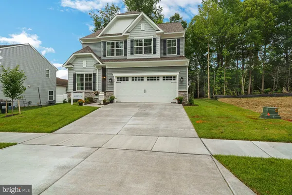 a front view of a house with yard