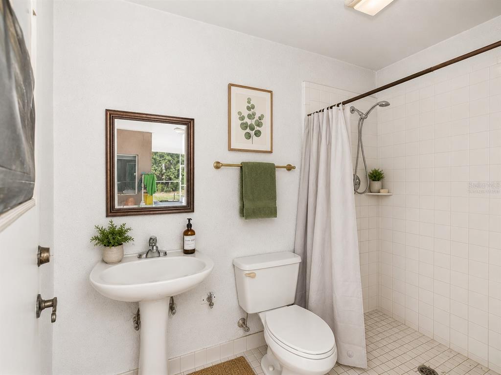 15420 Aubrey Avenue Spring Hill, FL 34610 - Photo 23 of 28 a bathroom with a sink toilet and a mirror