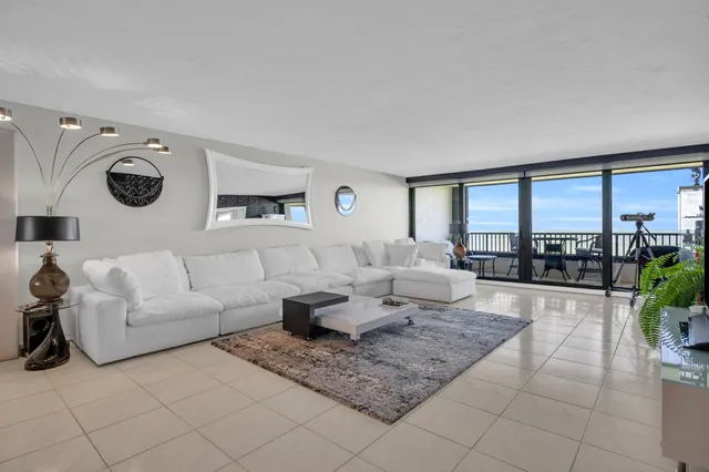 a view of a dining room with furniture and a chandelier