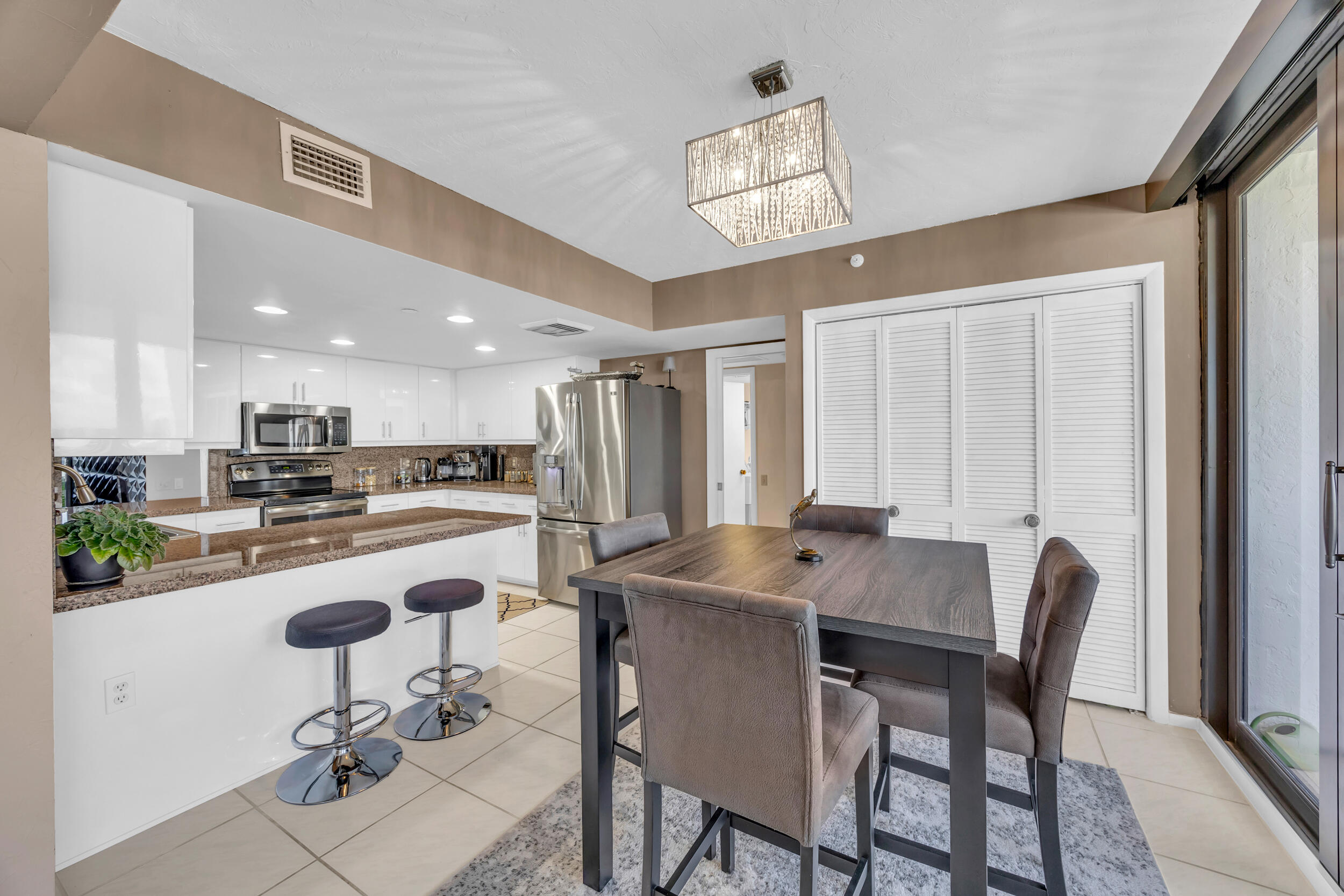 19900 South Beach Road, Unit 503 Jupiter, FL 33469 - Photo 25 of 51 a view of a dining room with furniture and a chandelier