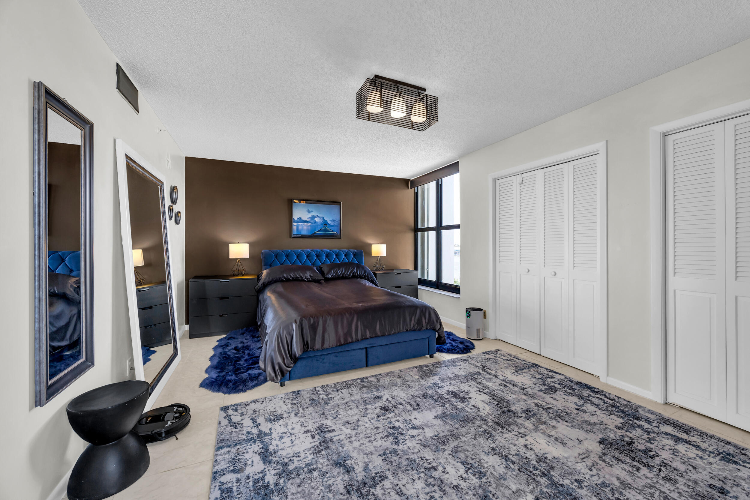 19900 South Beach Road, Unit 503 Jupiter, FL 33469 - Photo 41 of 51 a bedroom with a bed and a large mirror on the dresser