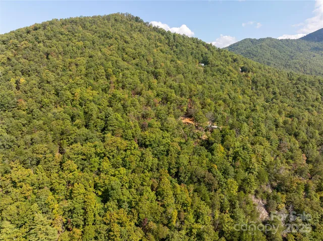 a view of a large mountain with a mountain in the background