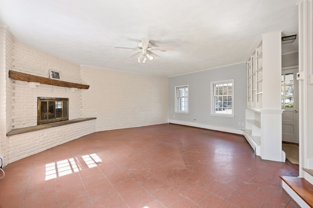8 Juniper Place Lexington, MA 02420 - Photo 12 of 42 a view of an empty room with a window and fireplace