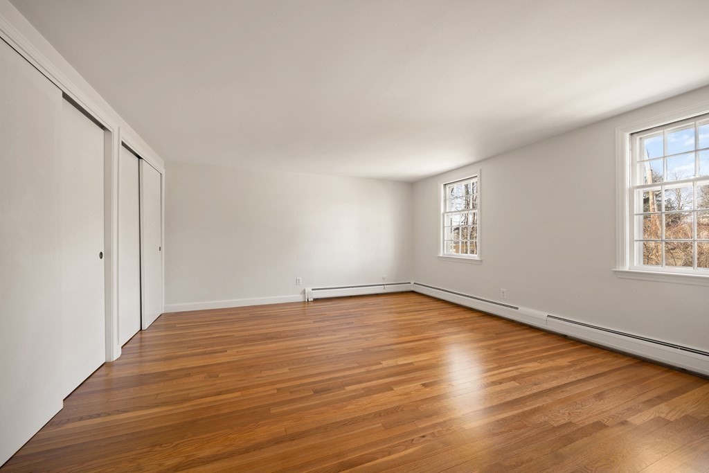 8 Juniper Place Lexington, MA 02420 - Photo 20 of 42 a view of an empty room with window and wooden floor