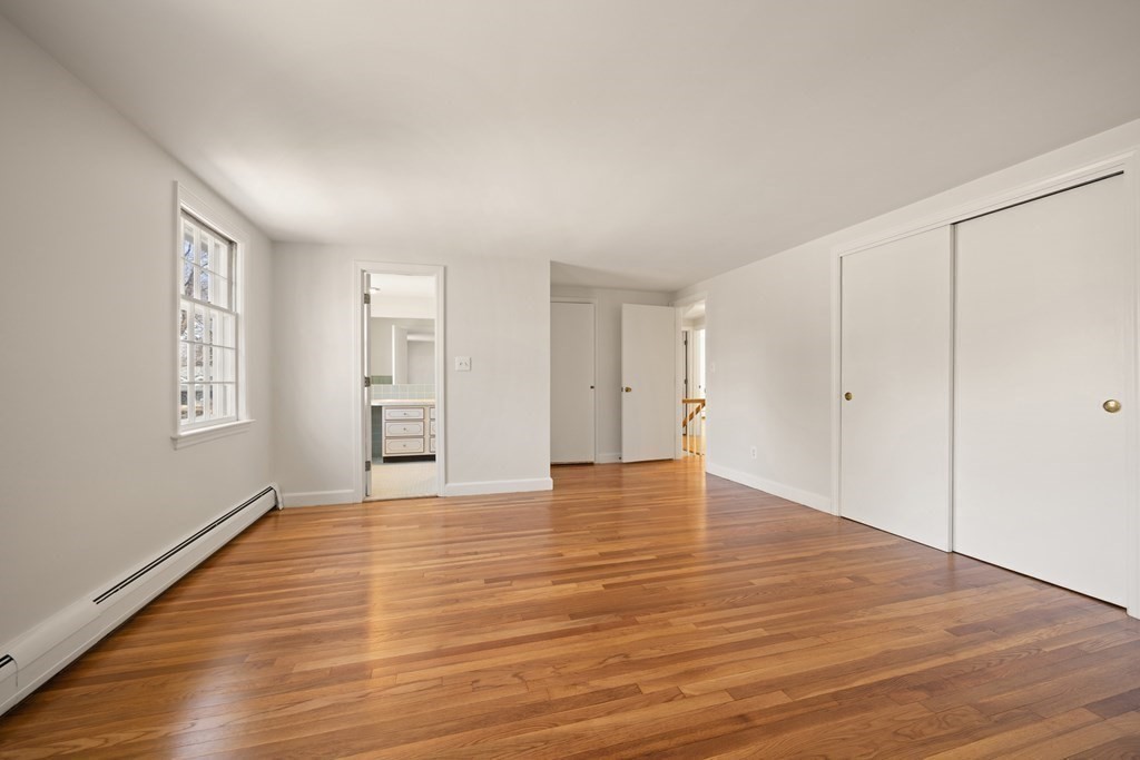 8 Juniper Place Lexington, MA 02420 - Photo 21 of 42 a view of empty room with wooden floor and window
